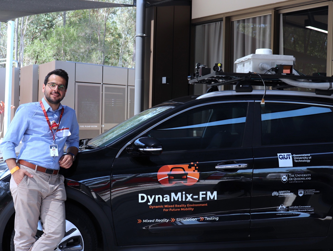 Ashkan Yousefi Zadeh beside an automated vehicle research platform